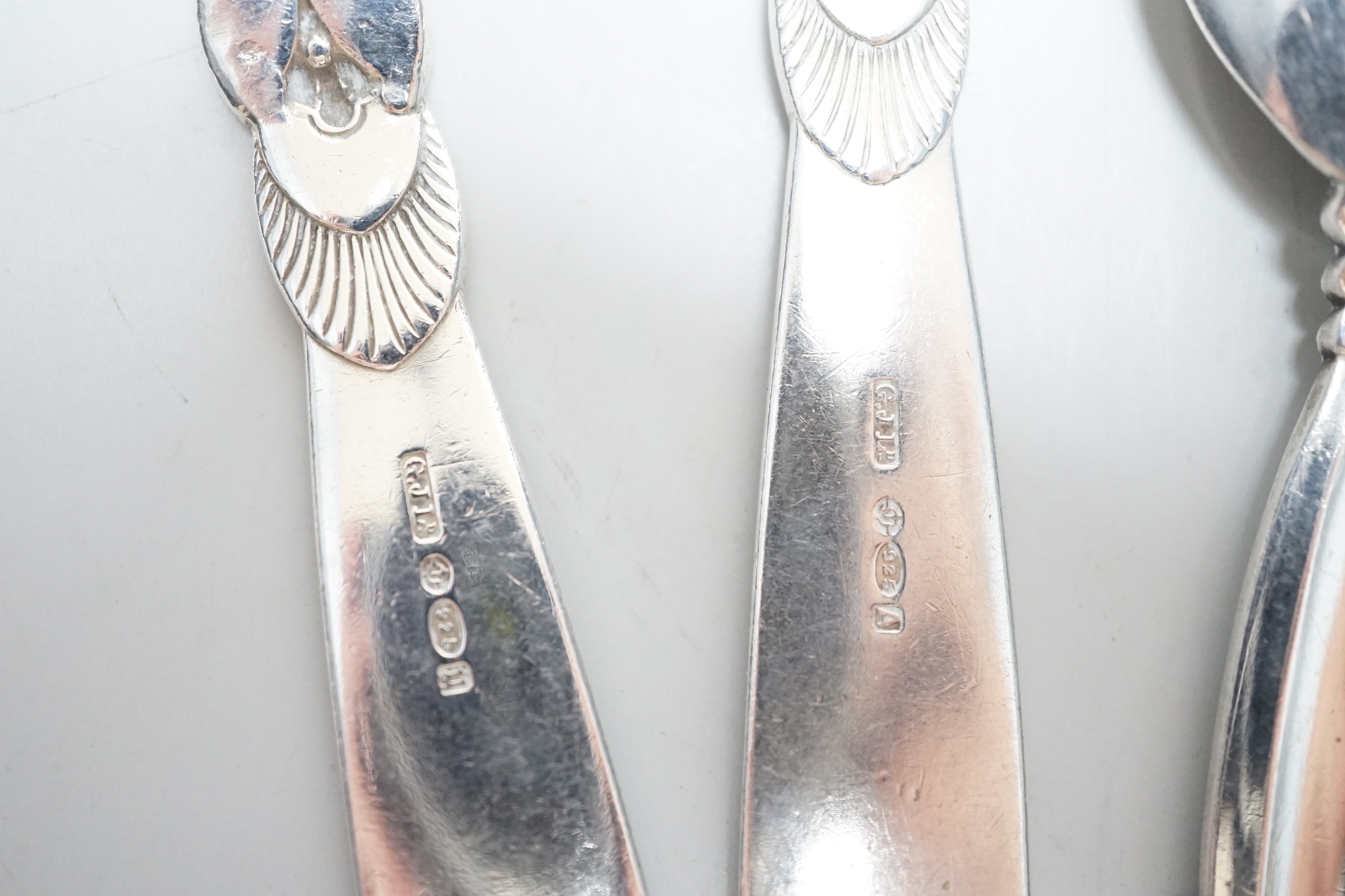 Five assorted items of Georg Jensen flatware including christening fork and spoon, caddy spoon, etc.